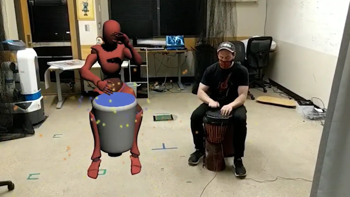 Drumming with a remote player rendered as an avatar.