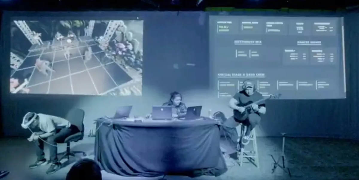 The CrowdForge performance space, with the guitarist, DJ, and projected mixed reality stage.