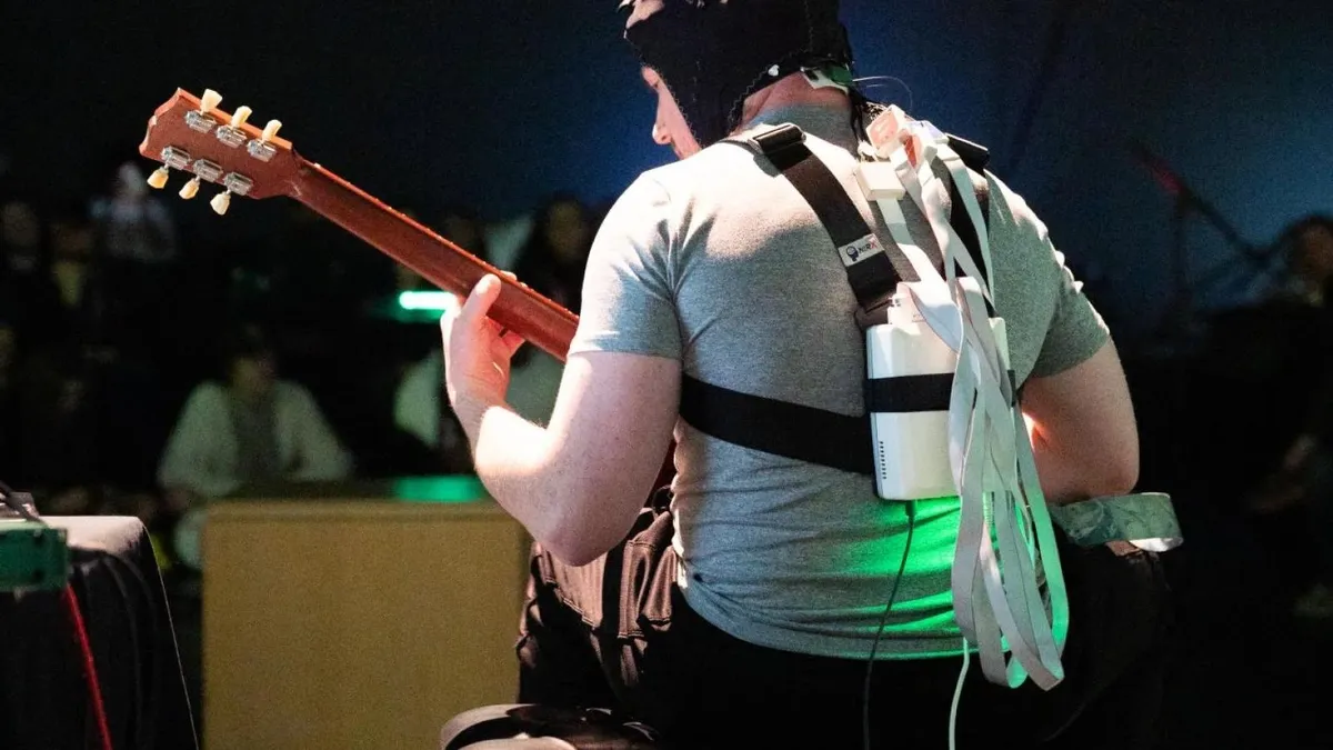 The guitarist performing while wearing the fNIRS device.